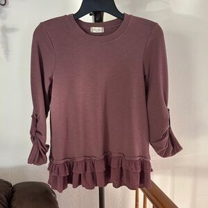 Altar’d state plum colored top with ruffle hem